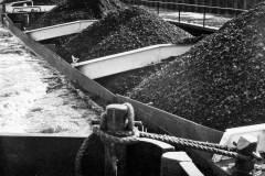 Train of three coal laden compartment boats.