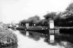 Four coal laden motor barges.