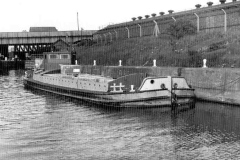 A motor barge, with a palletised cargo.