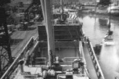 A motor vessel with open hold hatches.