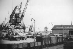 Unloading a bagged cargo onto heavy goods vehicles.