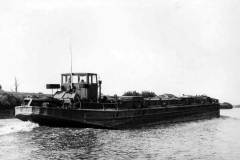 An unladen motor barge under way.