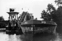 A bucket dredger and motor barge.