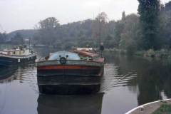 A motor barge entering a lock.