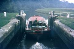 A motor barge leaving a lock.