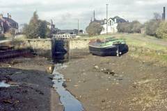 A motor barge stranded below a lock.