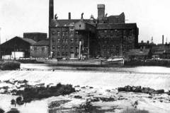A vessel alongside a Victorian building.