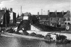 Loading coal into a motor barge.