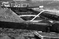 A coal-laden compartment boat in a lock.