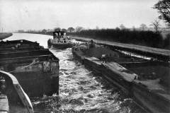 Compartment boat trains passing.