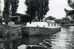 A moored converted barge.