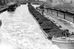 Compartment boat trains passing.