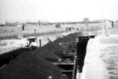 A compartment boat train and its tug.