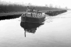A train of laden compartment boats.