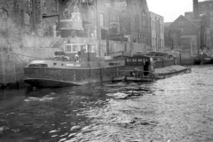 Barge Spurn Light moored alongside a building on a river.