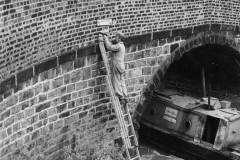 Affixing a sign on Bacon Bridge, Sheffield.