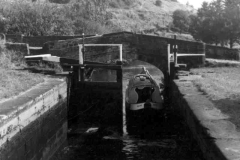 A narrowboat is entering lock