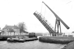 The barge Liliane passing beneath an open lift bridge.