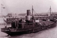Goole with its cargo of coke stacked high.
