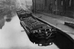 Coal-laden dumb barges moored alongside Sowerby Bridge Gasworks.