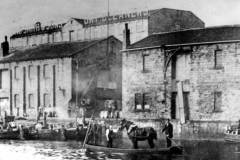 Three moored horse-drawn barges.