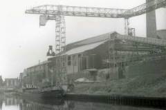 Mossdale moored alongside a large industrial facility.