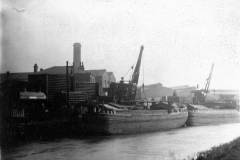 Two dumb barges with tubes being either loaded/unloaded.