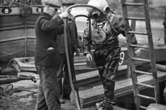 A diver with two support staff.