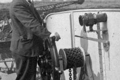 A  crewman at a vessel wheel.