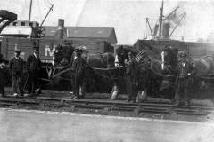 LMS staff posing in front of a row of the company\'s wagons.