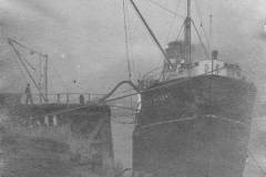 The oil tanker SS Pass of Leny is seen discharging its cargo at a jetty.