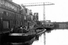 Barges Mossdale and Cordale moored alongside a very large industrial unit.