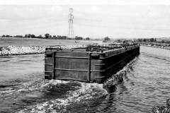 A tug and empty compartment boats.