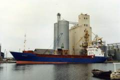 Margit moored alongside grain silos.