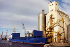 Gesche moored alongside grain silos.