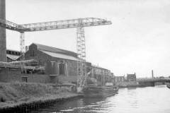 Barge moored at a canalside factory