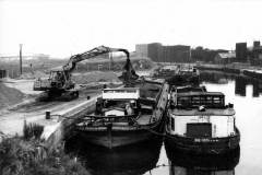 Barges being loaded with sand or gravel.