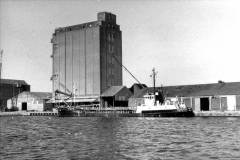 A motor vessel a grain storage facility.