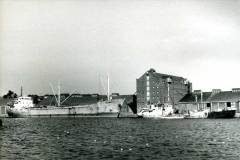 Falstria alongside a river quay.