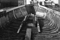 A wooden barge under repair