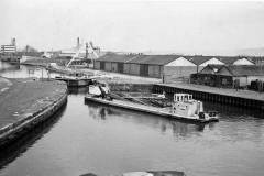 A dredger is approaching a lock.