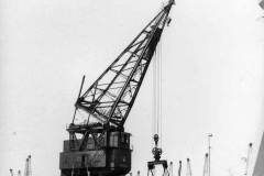 Goole\'s 50 ton crane is loading coal from a railway wagon into the collier Climping.