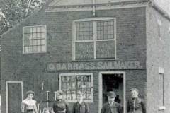 The owner and employees posing outside the premises of G Barrass, Sailmaker.