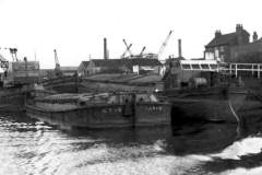 A crane-operated dredger and barge.