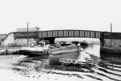 A barge passing under Lock Lane Bridge.