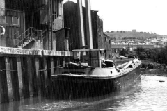 A  barge moored alongside a wharf.