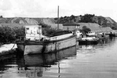 Two barges moored close to a lock.