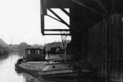 Two barges under a warehouse canopy