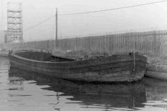 A sad looking, work weary dumb barge.