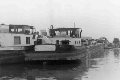 Two moored barges close to a power station.